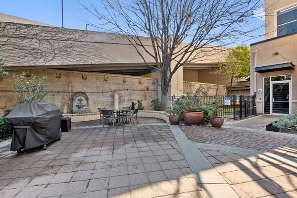 a view of a patio with table and chairs and potted plants