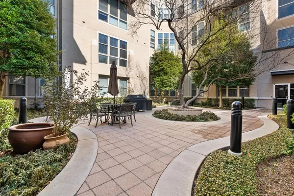 a view of a patio with table and chairs potted plants