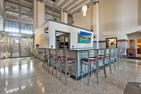 a room with lots of chairs and mirrors