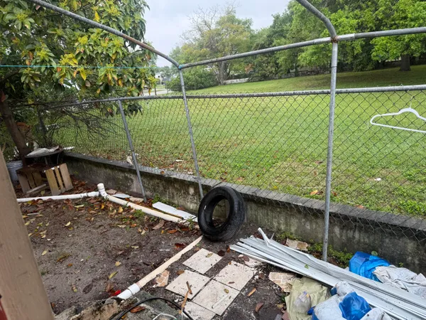 a backyard of a house with table and chairs