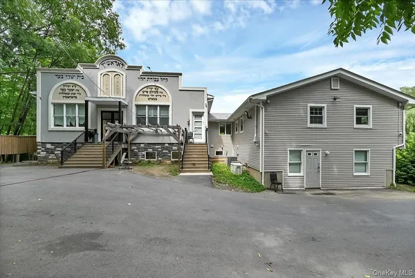 an aerial view of a house with a big yard and large trees