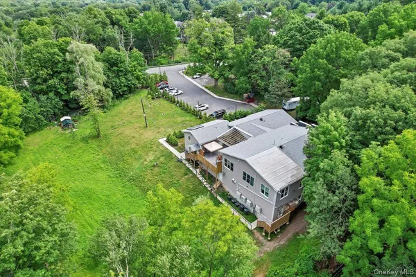 a view of a patio with a dining table and chairs with wooden floor