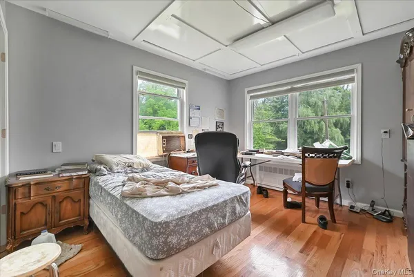a view of a workspace with furniture and wooden floor