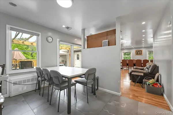 a view of a dining room with furniture and a book shelf