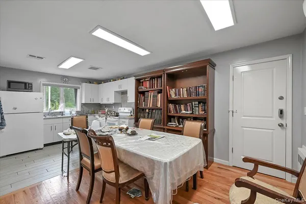 a kitchen with white cabinets stainless steel appliances and sink