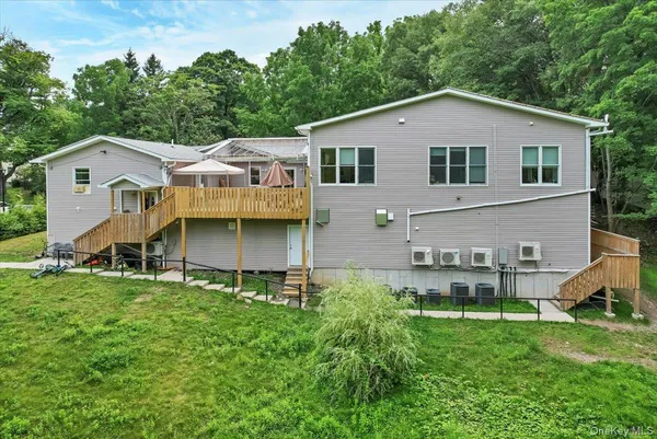 a view of a house with a yard and sitting area
