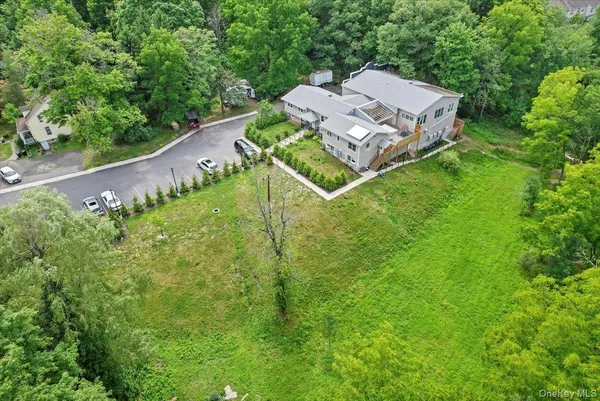 an aerial view of residential house with outdoor space and trees