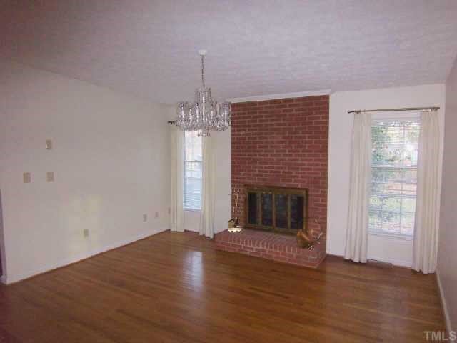 5909 Lake Elton Road Durham, NC 27713 - Photo 3 of 9 Family room is open to living room and has woodburning fireplace and brick hearth. Previous owner used this area as dining room.