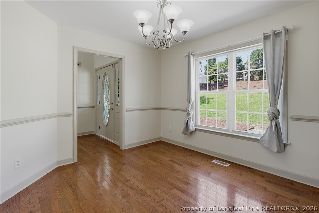 1075 Buffalo Lake Road Sanford, NC 27332 - Photo 8 of 49 wooden floor in an empty room with a window