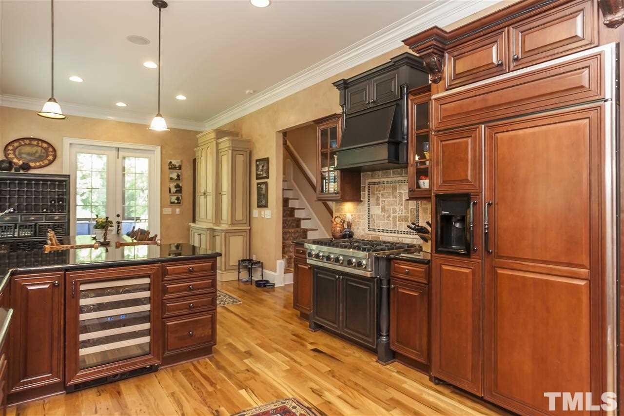 2933 Claremont Road Raleigh, NC 27608 - Photo 12 of 25 a kitchen with stainless steel appliances granite countertop a stove a refrigerator and a refrigerator