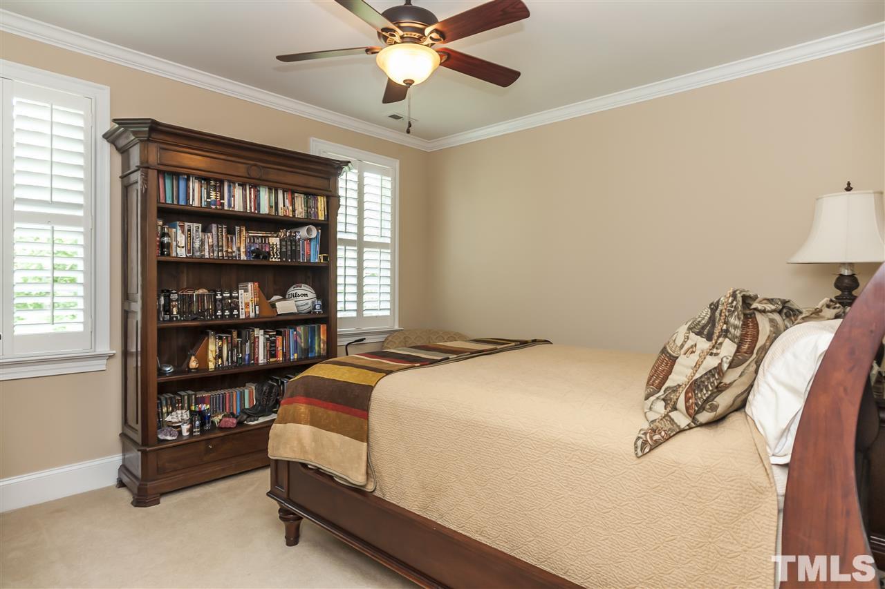 2933 Claremont Road Raleigh, NC 27608 - Photo 19 of 25 a bedroom with a bed and a book shelf