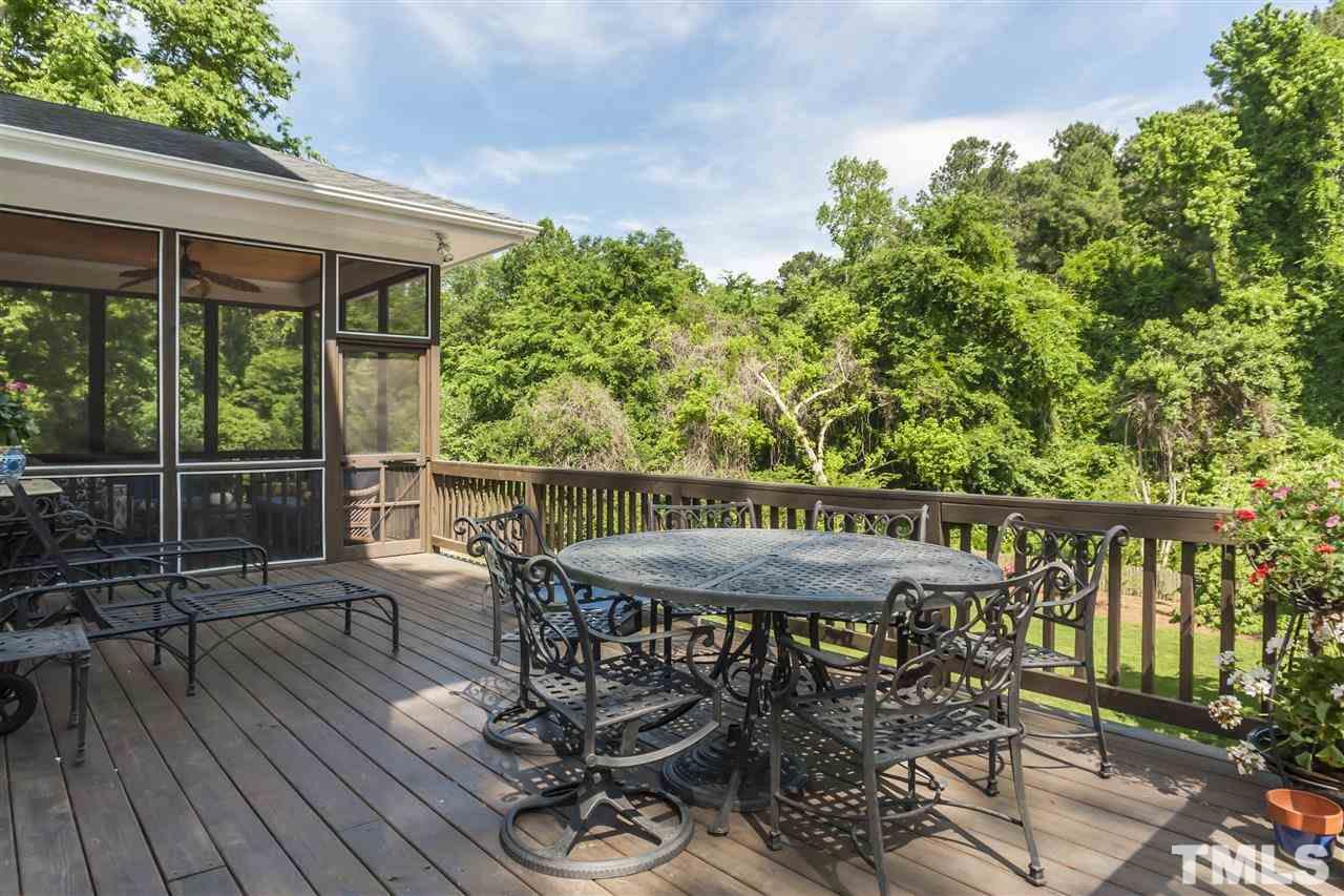 2933 Claremont Road Raleigh, NC 27608 - Photo 23 of 25 a patio with wooden floor a yard a table and chairs