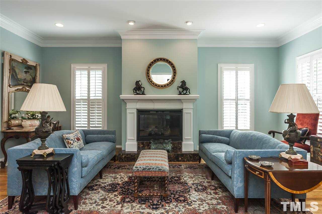 2933 Claremont Road Raleigh, NC 27608 - Photo 5 of 25 a living room with furniture and a fireplace