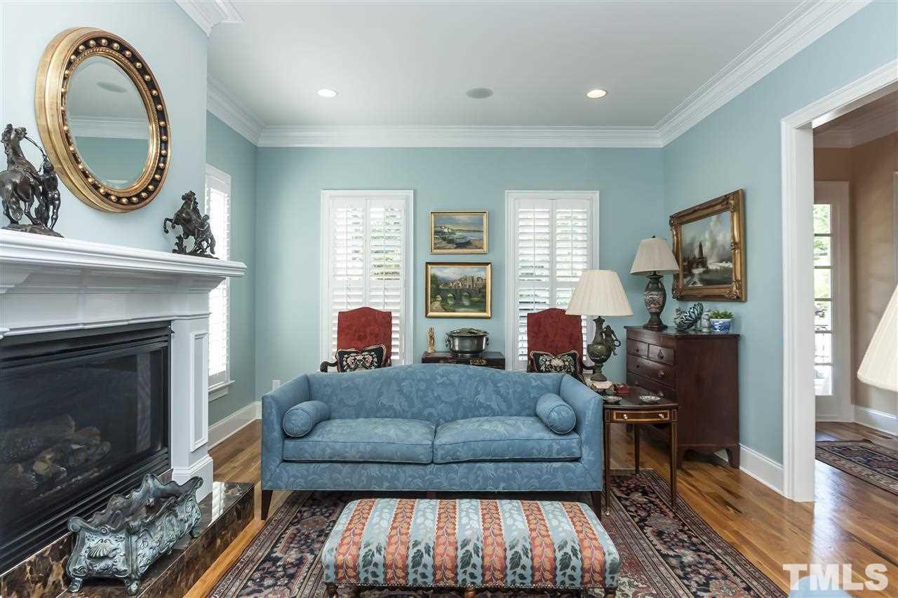 2933 Claremont Road Raleigh, NC 27608 - Photo 6 of 25 a living room with furniture and a fireplace
