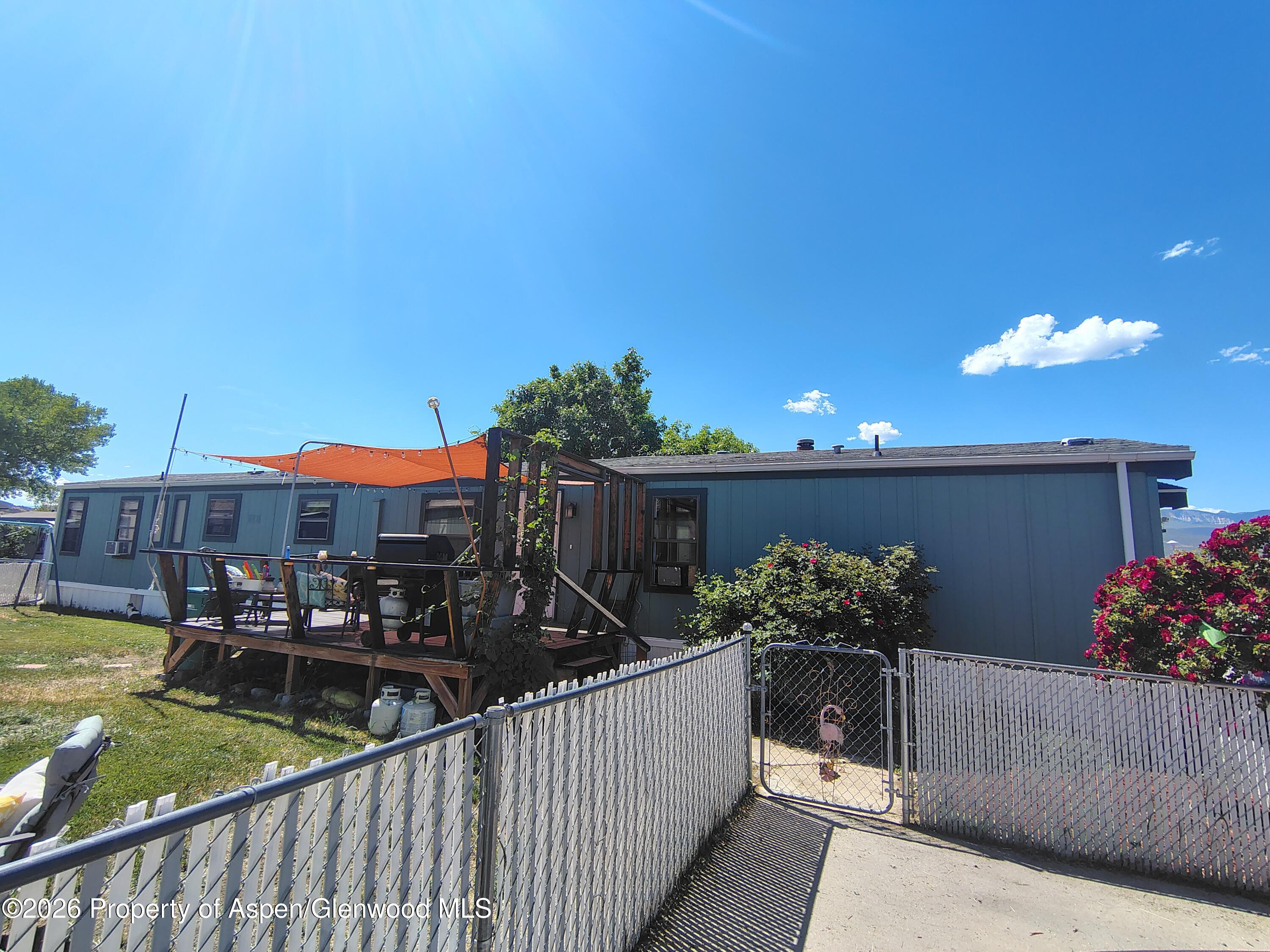 a view of a house with wooden fence