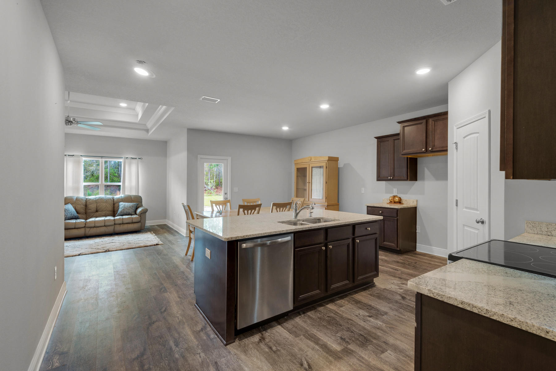 214 Southern Pines Road Santa Rosa Beach, FL 32459 - Photo 3 of 27 a large kitchen with stainless steel appliances kitchen island granite countertop a sink and cabinets