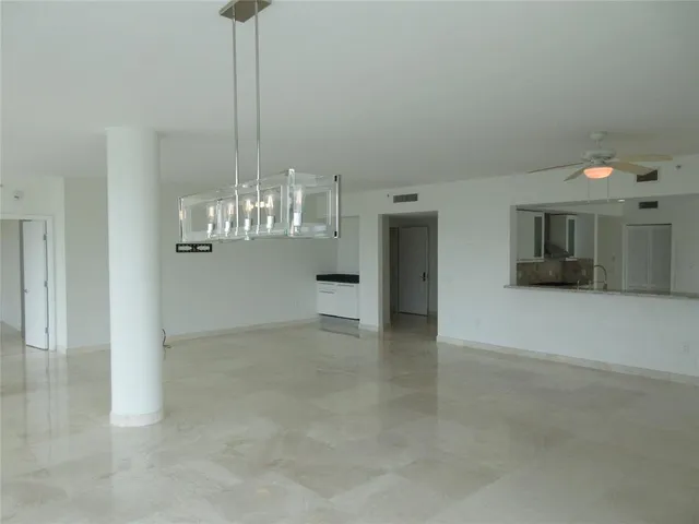 a view of kitchen with furniture and a ceiling fan