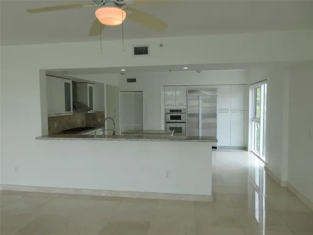 a view of an empty room with a fireplace