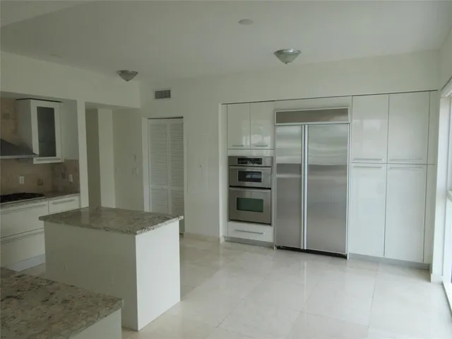 a kitchen with granite countertop a sink and a stove