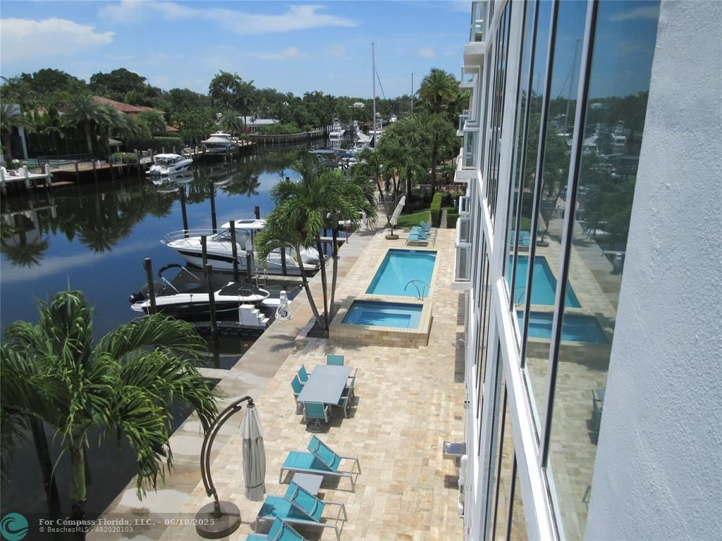 45 Hendricks Isle, Unit 301 Fort Lauderdale, FL 33301 - Photo 23 of 26 a view of a lake with a floor to ceiling window and plants