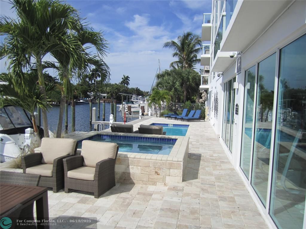 45 Hendricks Isle, Unit 301 Fort Lauderdale, FL 33301 - Photo 7 of 26 a view of a patio with couches table and chairs potted plants and palm tree