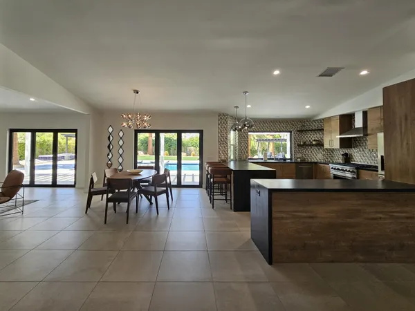 a kitchen with stainless steel appliances wooden cabinets and stove top oven