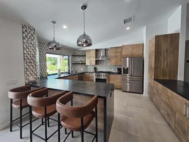 a living room with furniture or chandelier and a wooden floor