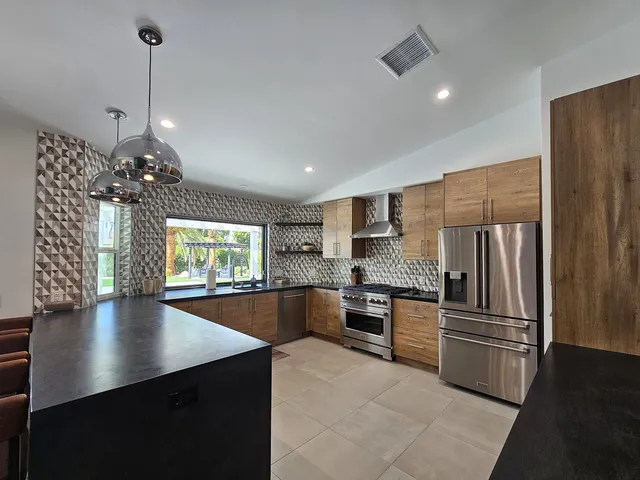 a living room with furniture a ceiling fan and a fireplace
