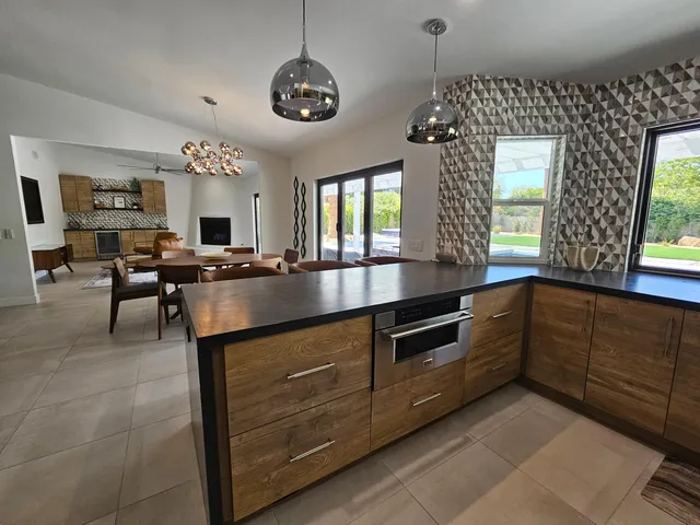 a spacious bedroom with a bed and glass windows