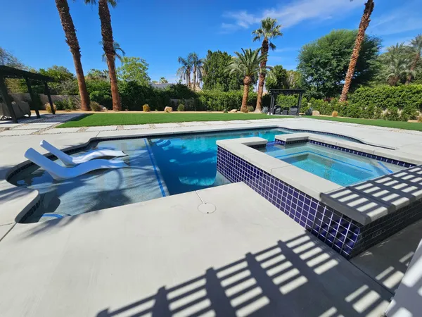 a view of a backyard with sitting area