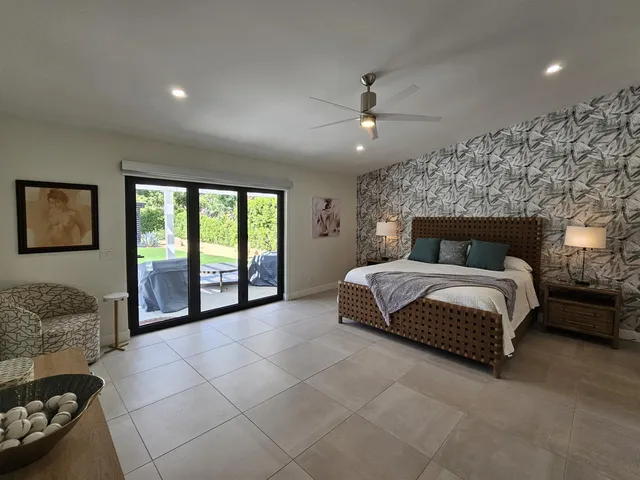 a bedroom with two beds and painting on the wall