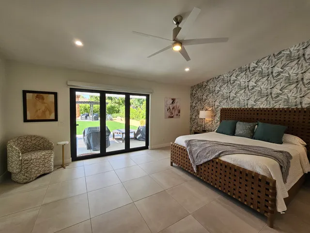 a bedroom with two beds and painting on the wall