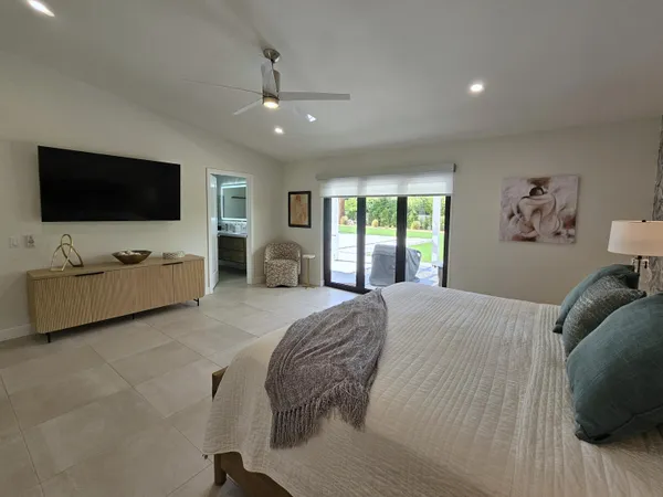 a bedroom with two beds and painting on the wall