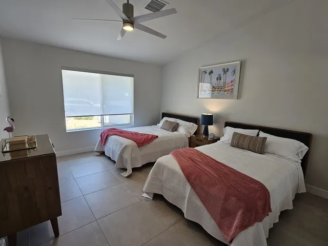 a view of a house with swimming pool and sitting area