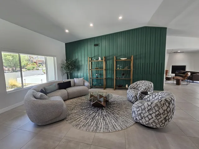 a kitchen with stainless steel appliances granite countertop a refrigerator a sink dishwasher a stove and a dining table with wooden floor