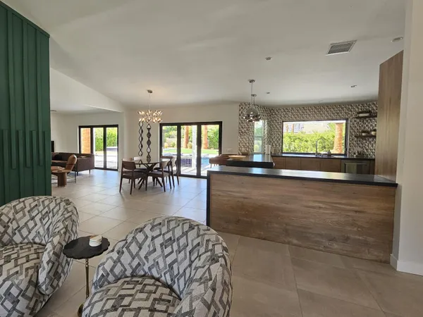 a kitchen with stainless steel appliances kitchen island granite countertop a stove a sink and a microwave