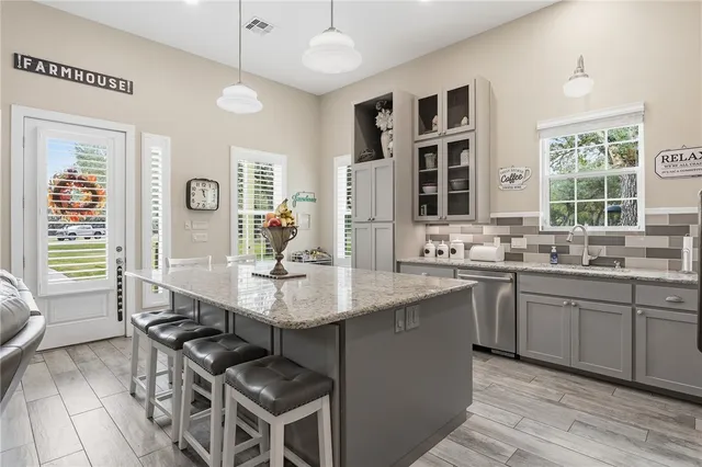 a kitchen with stainless steel appliances granite countertop a sink and stove
