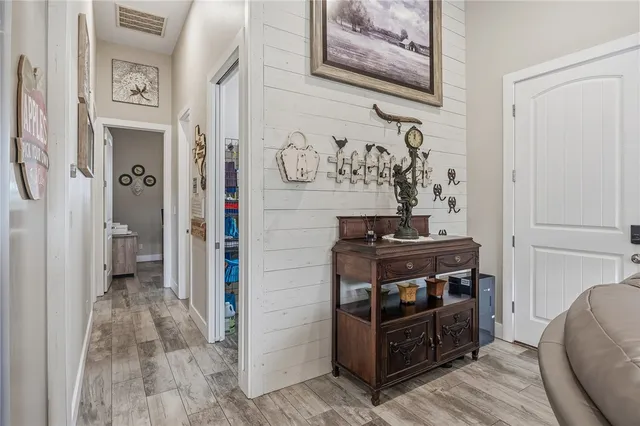 a bedroom with a bed and dresser with mirror