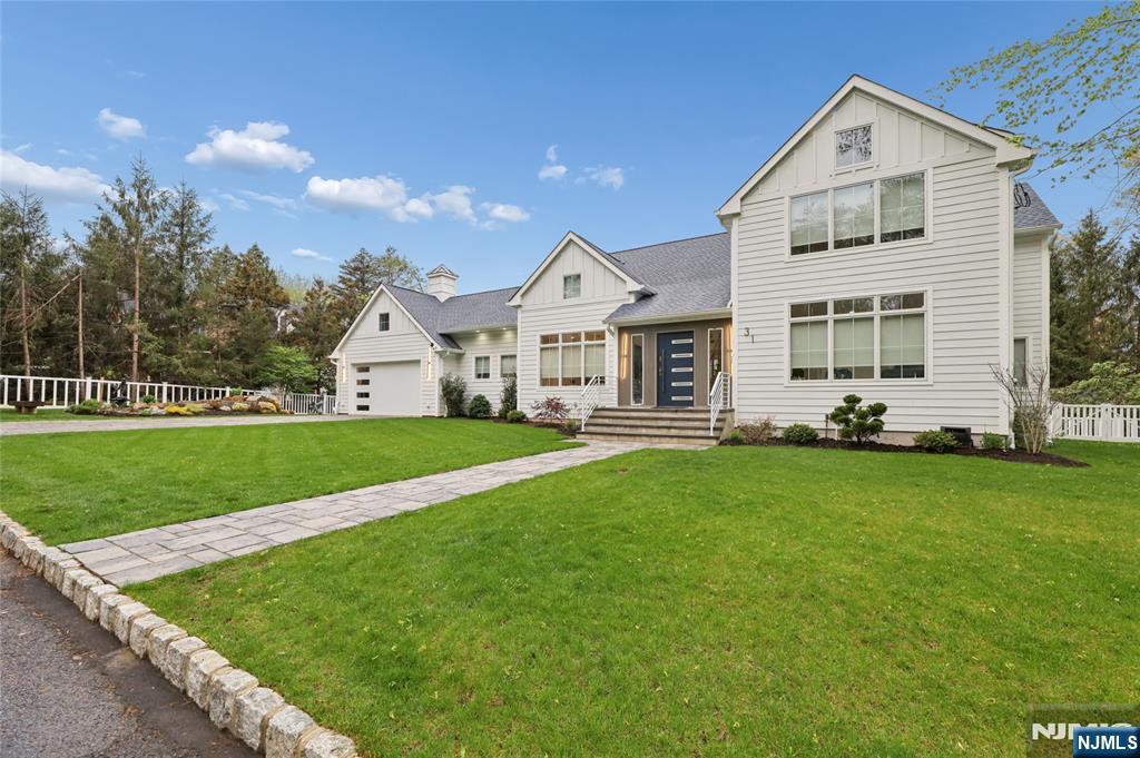 31 Engleside Street Cresskill, NJ 07626 - Photo 45 of 49 a front view of a house with a yard and trees
