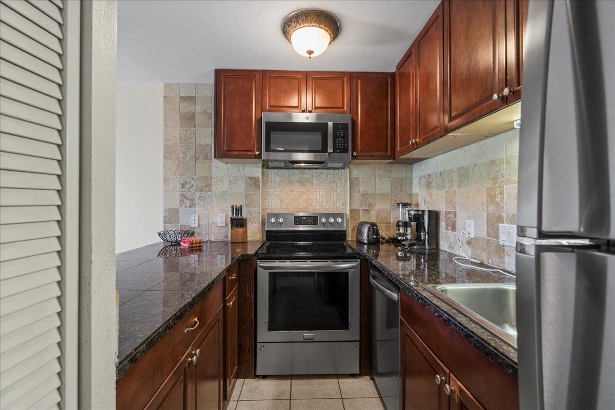 4909 Lower Honoapiilani Road, Unit E2E Lahaina, HI 96761 - Photo 13 of 42 a kitchen with a sink and steel appliances