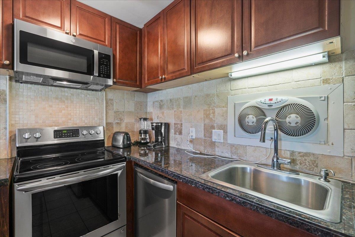 4909 Lower Honoapiilani Road, Unit E2E Lahaina, HI 96761 - Photo 14 of 42 a kitchen with a sink and cabinets