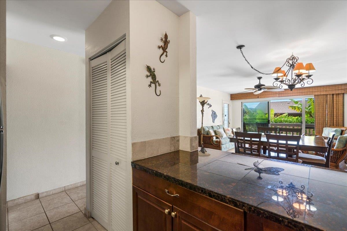 4909 Lower Honoapiilani Road, Unit E2E Lahaina, HI 96761 - Photo 16 of 42 a kitchen with granite countertop a sink and a stove