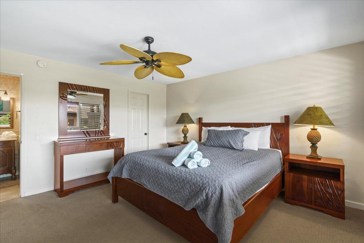 4909 Lower Honoapiilani Road, Unit E2E Lahaina, HI 96761 - Photo 24 of 42 a bedroom with a bed and ceiling fan