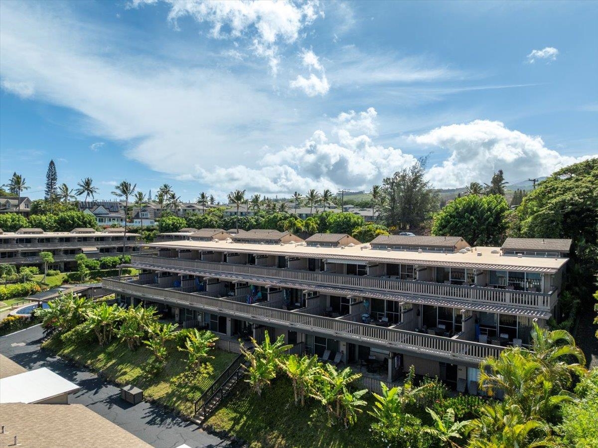 4909 Lower Honoapiilani Road, Unit E2E Lahaina, HI 96761 - Photo 30 of 42 a view of a large building with a big yard and potted plants