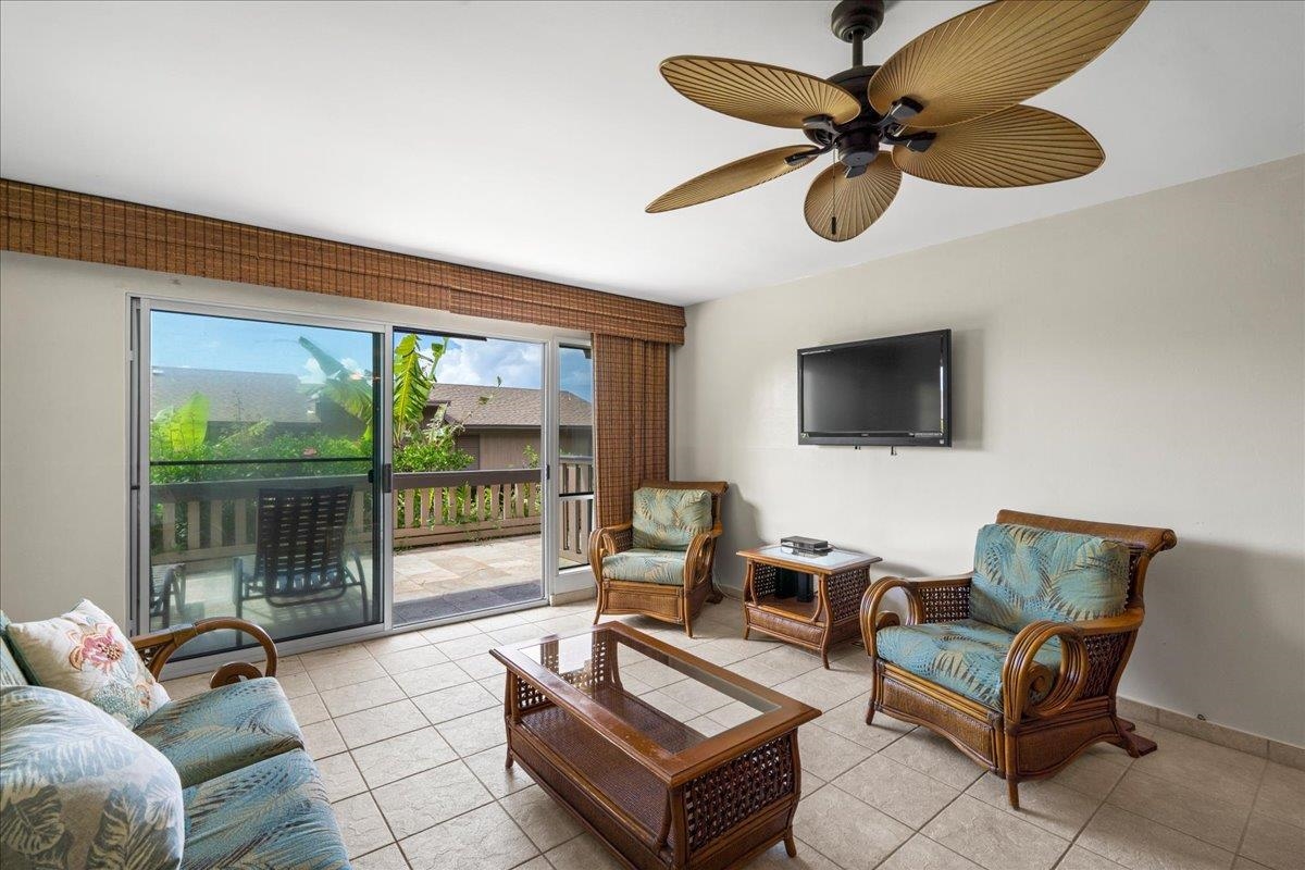 4909 Lower Honoapiilani Road, Unit E2E Lahaina, HI 96761 - Photo 10 of 42 a living room with furniture a flat screen tv and a large window