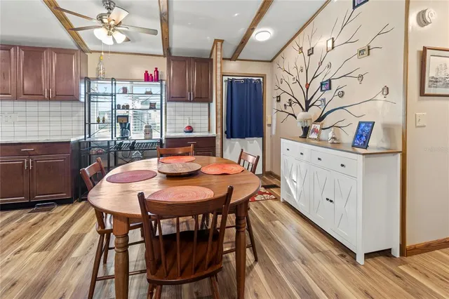 a view of a dining room with furniture and a potted plant