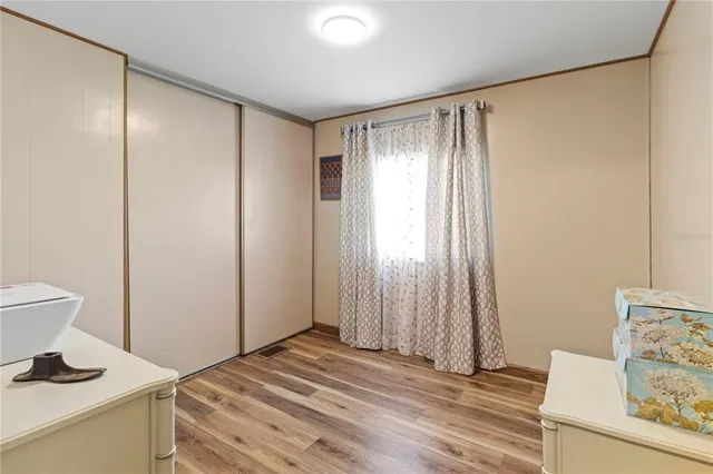 a view of a patio with table and chairs potted plants with wooden floor