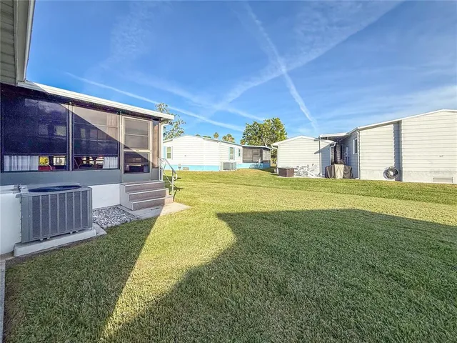 a view of a house with swimming pool and sitting area