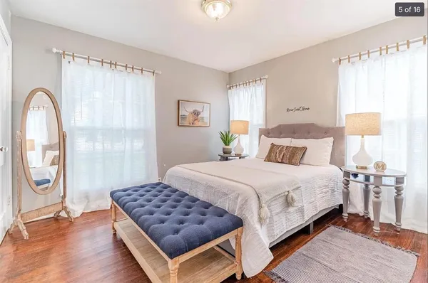 a bedroom with a bed and a painting on the wall