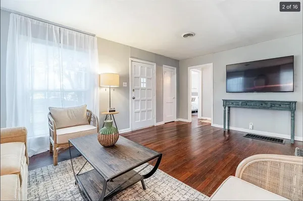 a living room with fireplace furniture and a flat screen tv